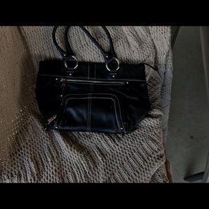 Selling a wide selection of purses.